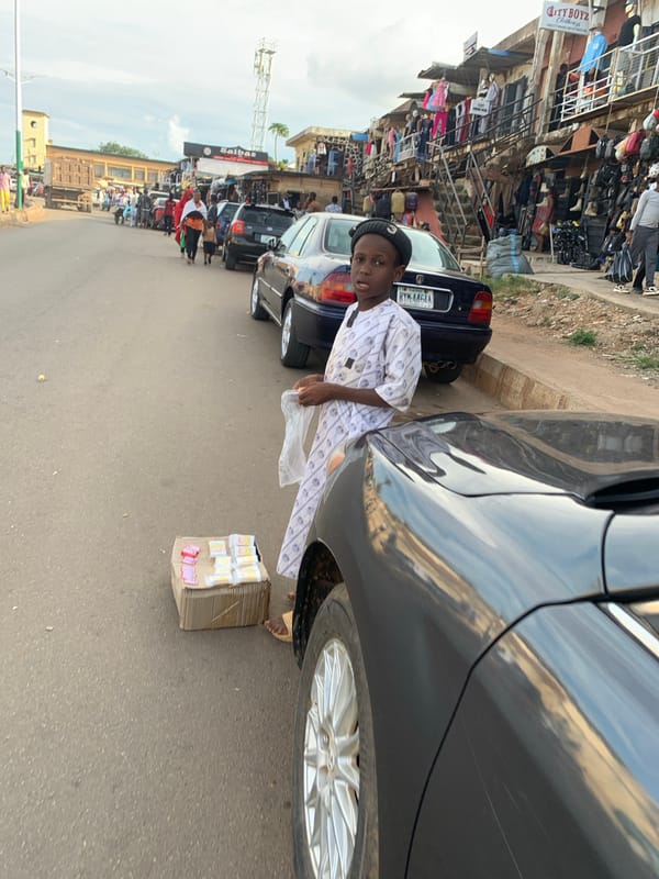 Afternoon foot traffic on a commercial street in Jos, Nigeria