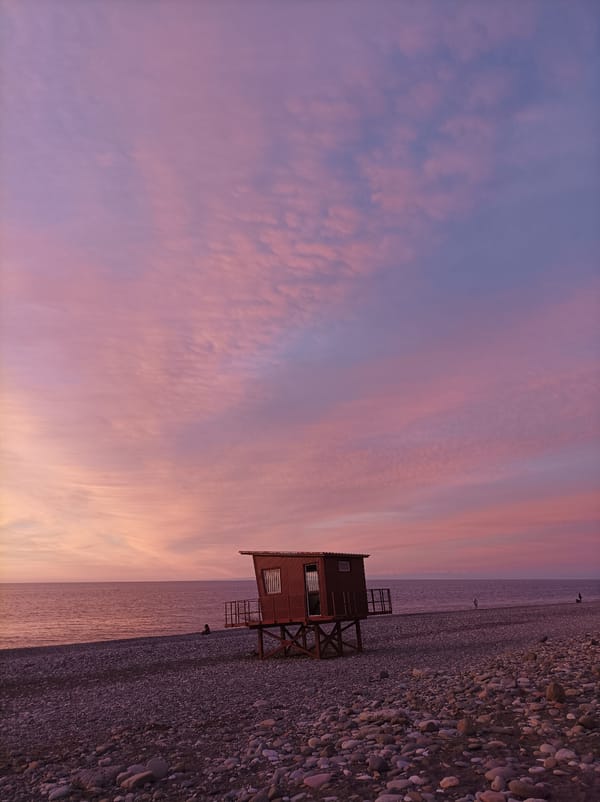 Sunset at beach lifeguard station with colorful sky