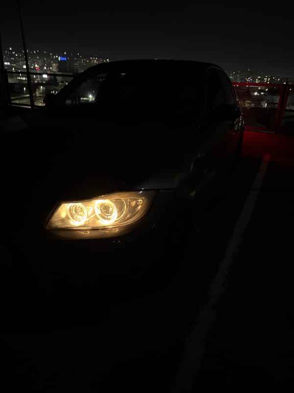 Car headlight illuminated in darkness in Varna at night