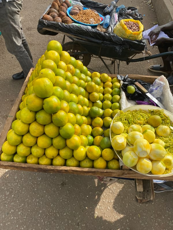 Street vendors sell citrus fruits and grilled corn in Bukuru