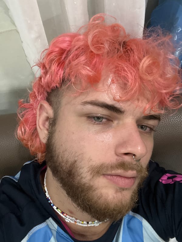 Pink-haired man photographed in Đà Nẵng indoor portrait session