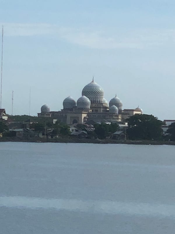 Early morning scenes captured around Lhokseumawe mosque and waterway