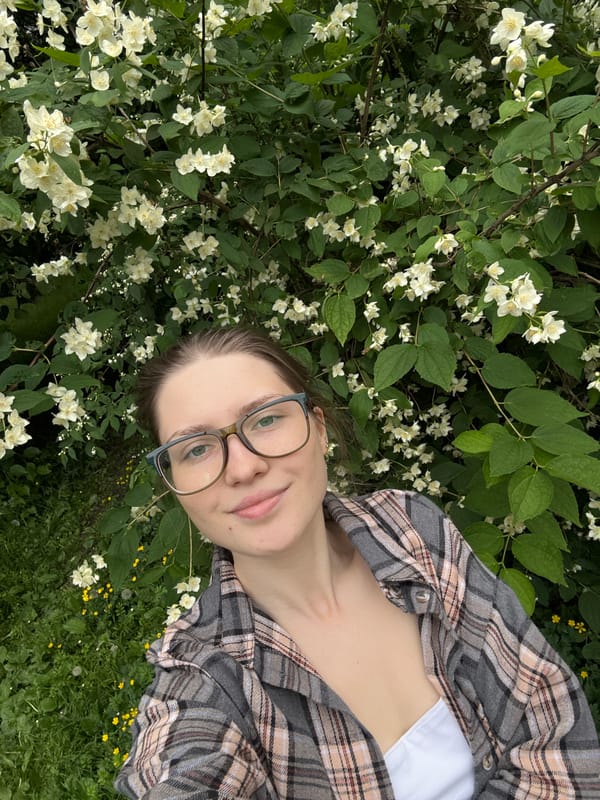 Woman photographs jasmine blooms in Saint Petersburg park