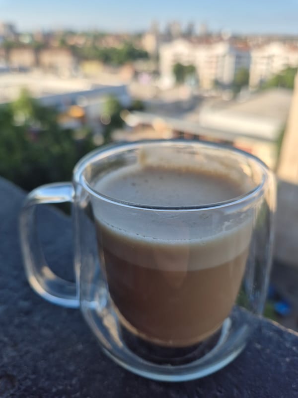 Morning coffee and selfies on a rooftop with a city view