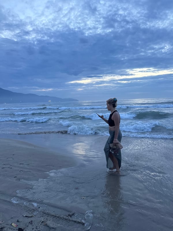 Beachgoers photograph sunset moments at Đà Nẵng shore