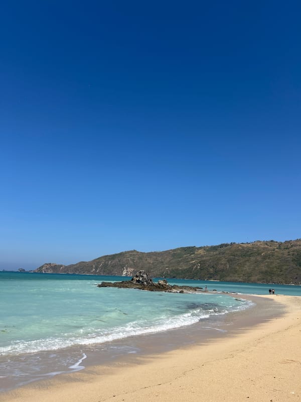 Kuta Beach, Lombok — shoreline and beachfront walkway on a clear day