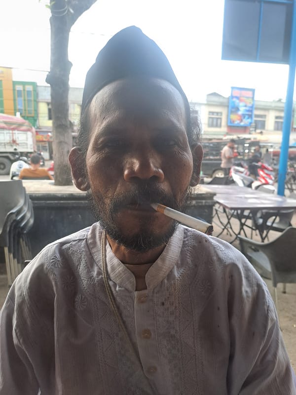 Man enjoys morning coffee at Indonesian cafe