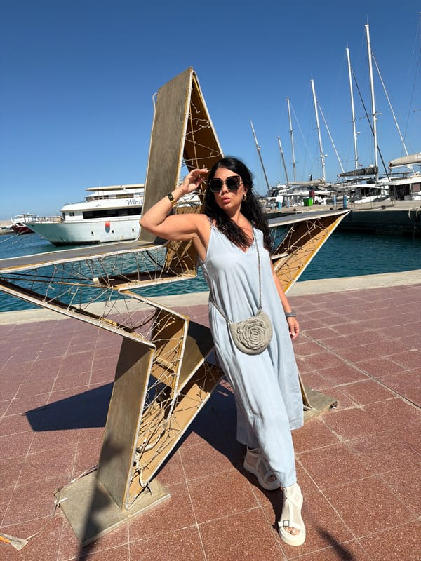 Tourist poses with star sculpture at Hurghada marina