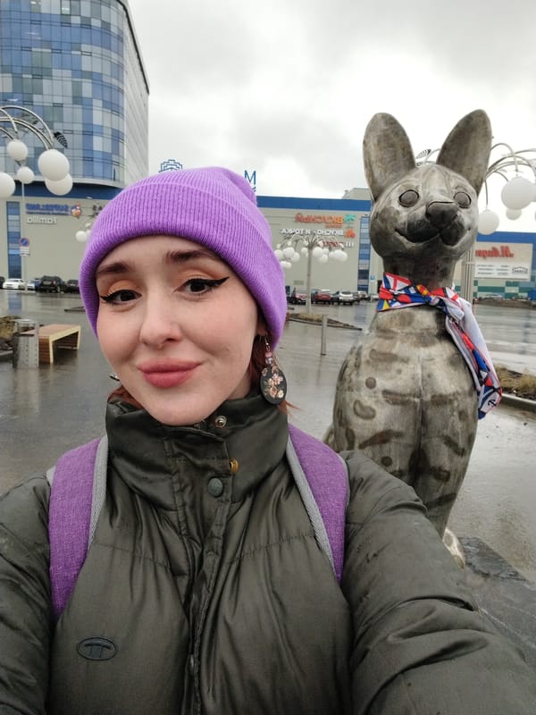 Woman Takes Selfie with Decorated Dog Statue in Izhevsk