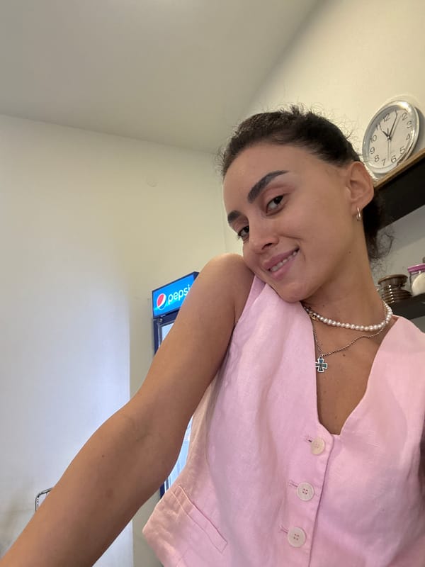 Indoor selfie in Tbilisi, pink top and pearl necklace