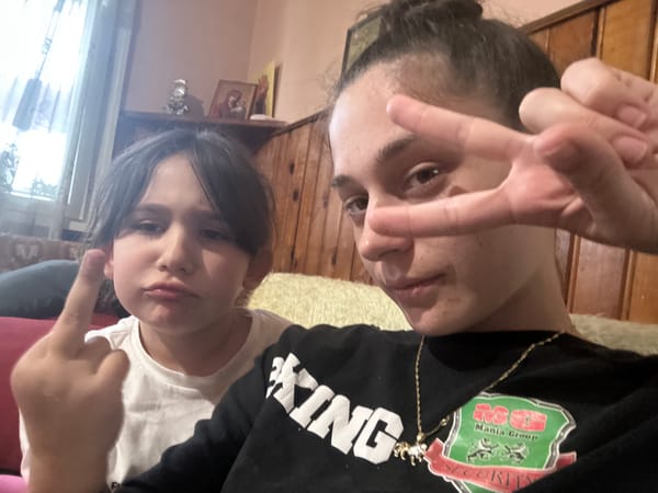 Adult and child take playful selfies in Resen, Bulgaria