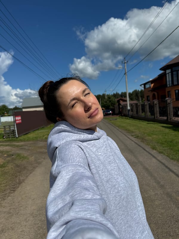 Woman takes selfie on road in Vysokinichi, Russia