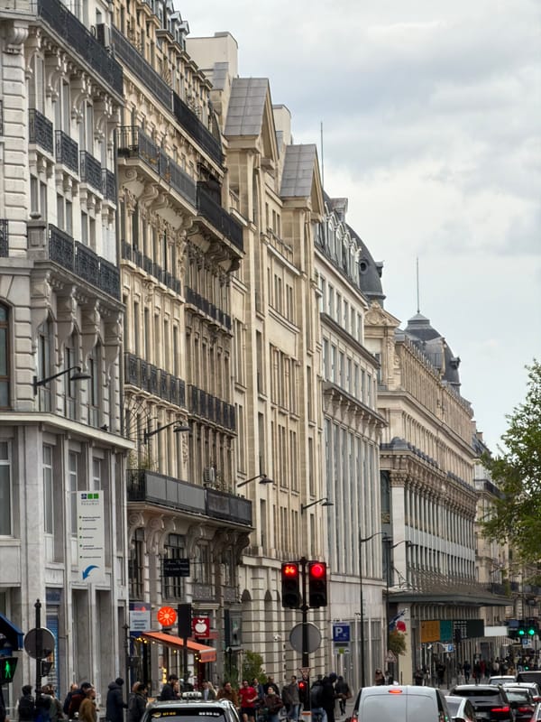 Pedestrians navigate Paris streets during afternoon rush hour
