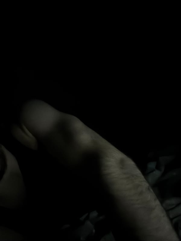 Person photographed resting in bed in Pentre evening