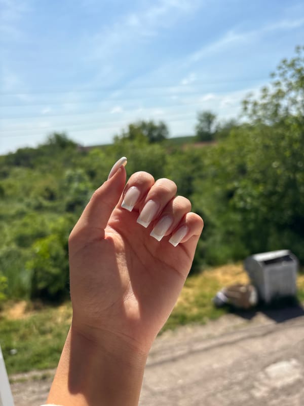 Hand with white nails photographed in Bulgarian village