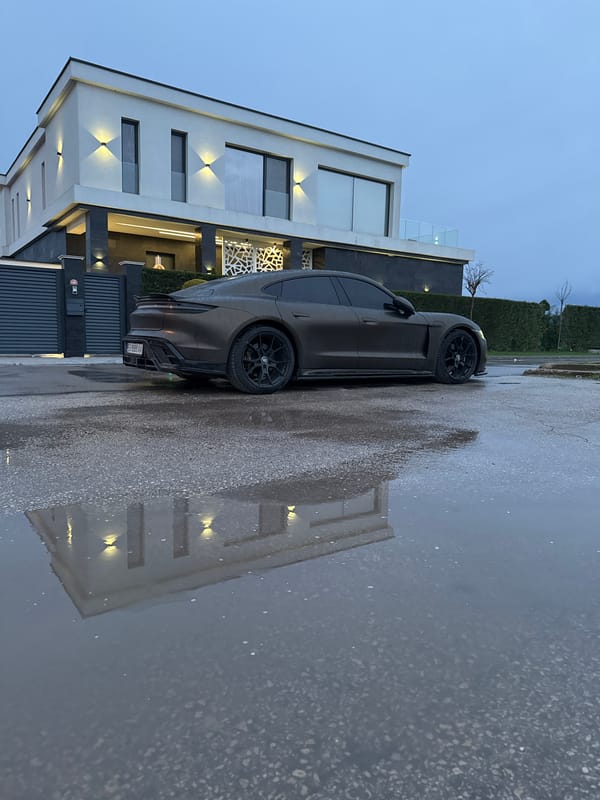 Gray Porsche parked on wet street in Kazashko, Bulgaria
