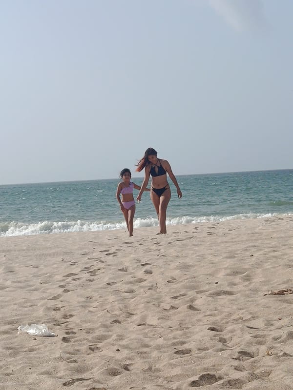 Woman and child enjoy evening beach time in Venezuela