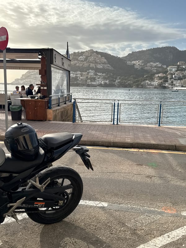 Motorcycle parked outside dining kiosk in Andratx Spain