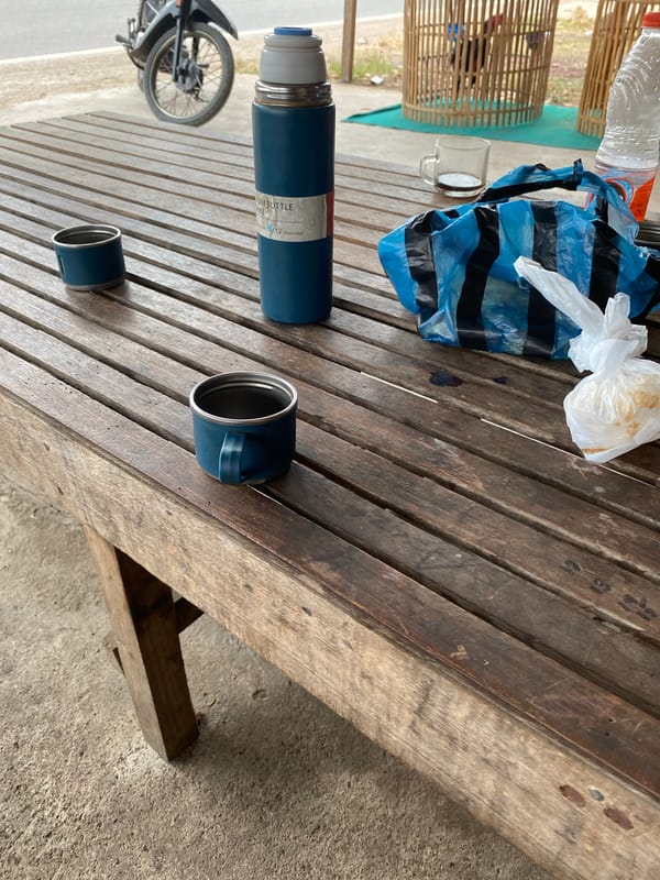 Casual outdoor rest stop around a wooden table in Bayu