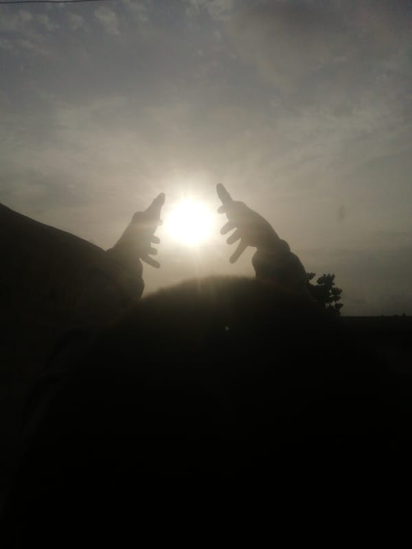 Morning silhouettes: arms raised skyward, figure resting below