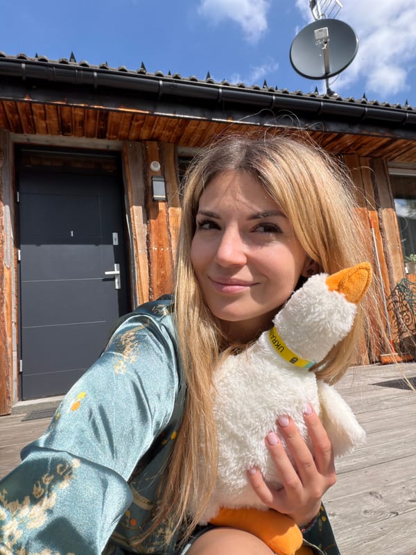 Woman poses with Ukraine-themed stuffed goose in Wisła, Poland