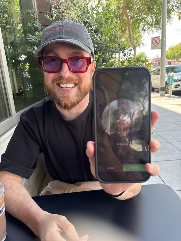 Man with smartphone, Erewhon drinks photographed in West Hollywood