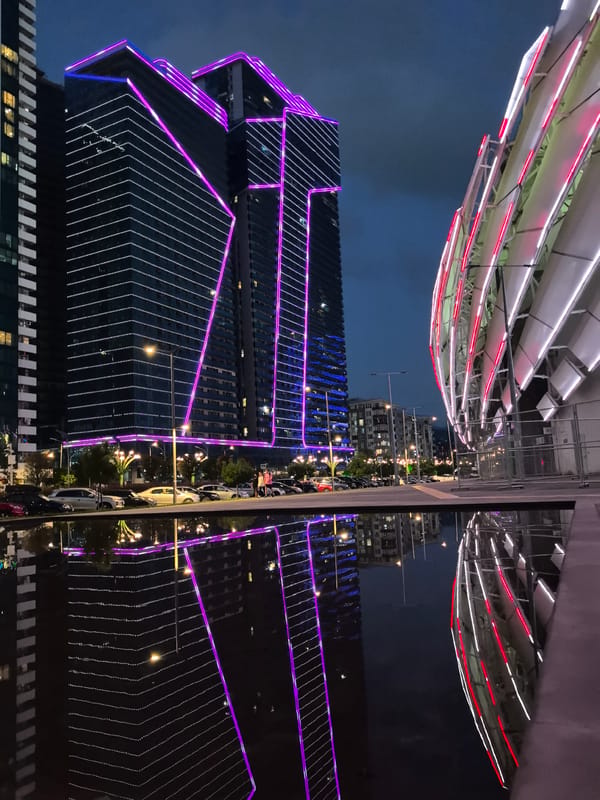 Batumi's neon-lit waterfront skyline at dusk
