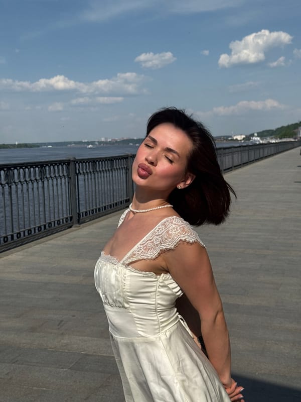 Woman poses for photos along Perm waterfront promenade