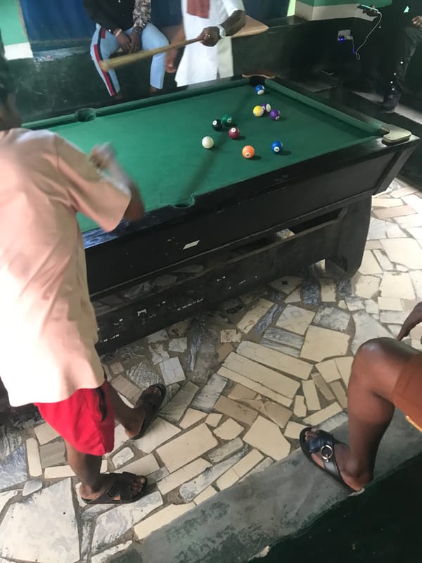 Person plays pool at rustic bar venue