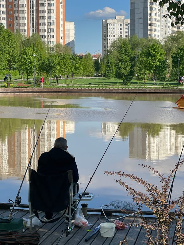 Anglers fish from wooden dock in Moscow park