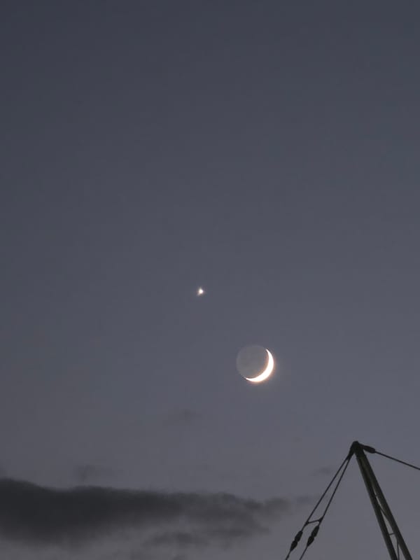 Crescent moon and star at dusk over Podgorica