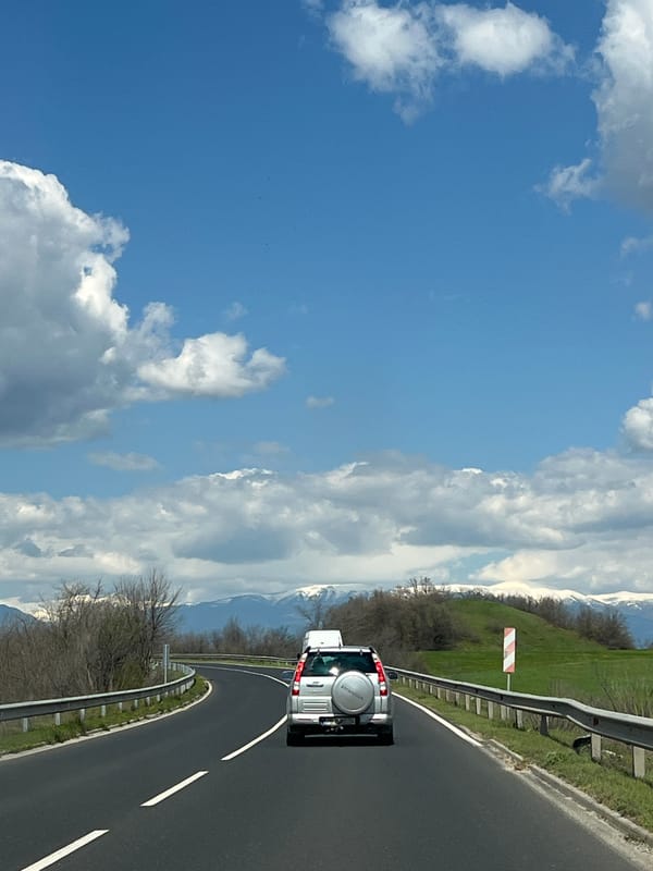 Silver car travels mountain road in Bulgaria