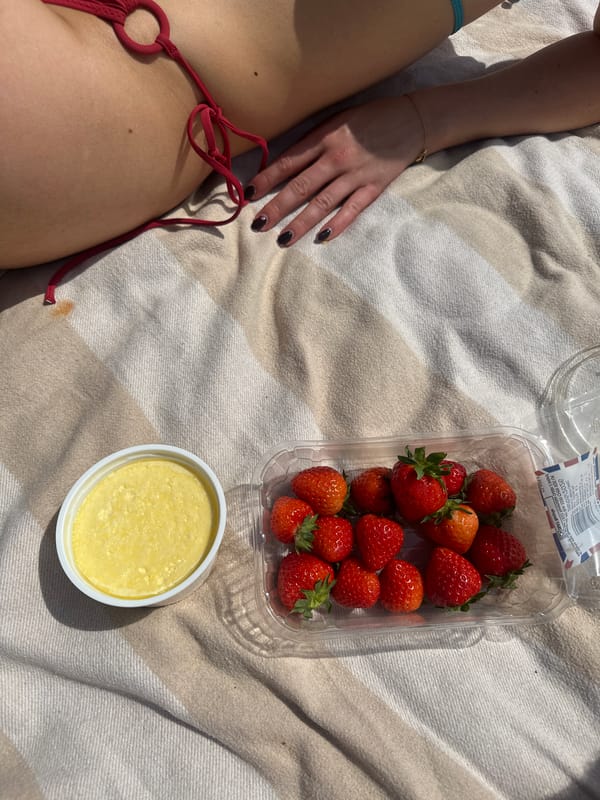 London park visitor enjoys sunny afternoon picnic and sunbathing