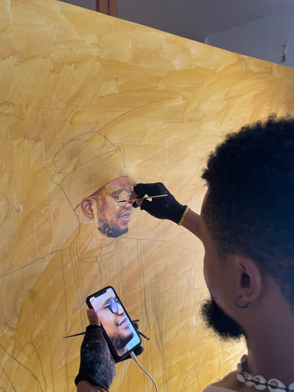 Artist documents painting session in Ado, Nigeria studio