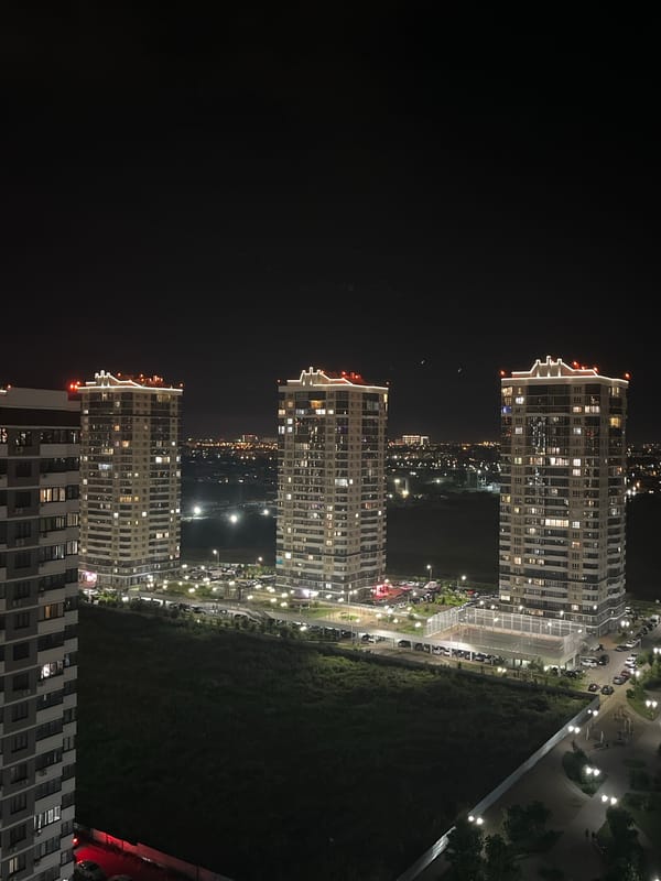 Nighttime aerial views of residential towers and an Orthodox church