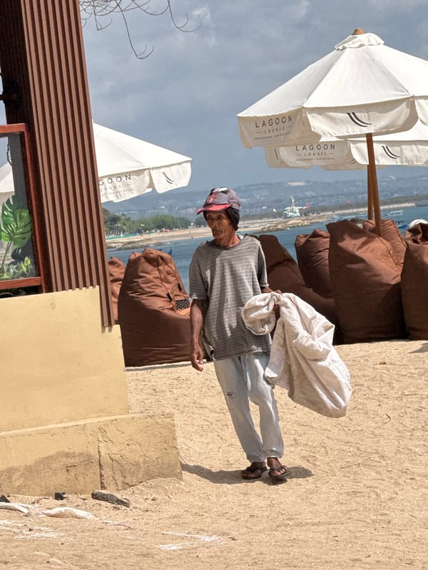 Busy morning on Kuta Beach: surf, lessons, and shoreline life