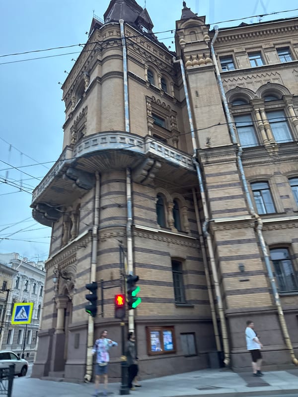 Ornate brick architecture and evening traffic in Saint Petersburg