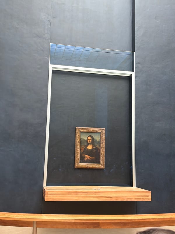 Visitor documents Mona Lisa and ornate ceiling at Louvre Museum