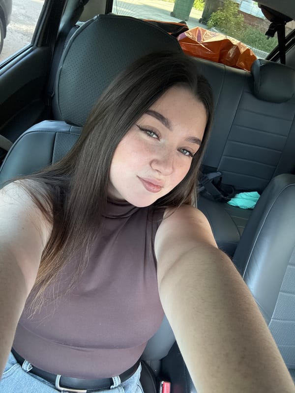Woman takes selfie in car driver's seat in Perm