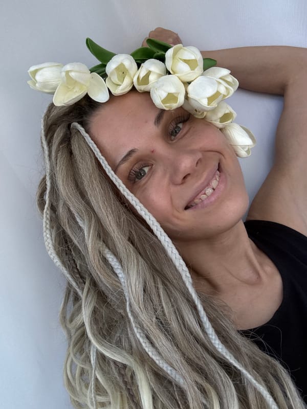 Woman poses for photo session with flowers in Rusanovo