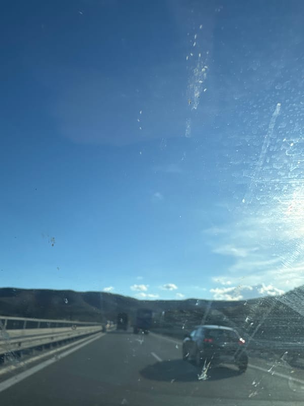 Car window view captures blue sky, highway in Bulgaria