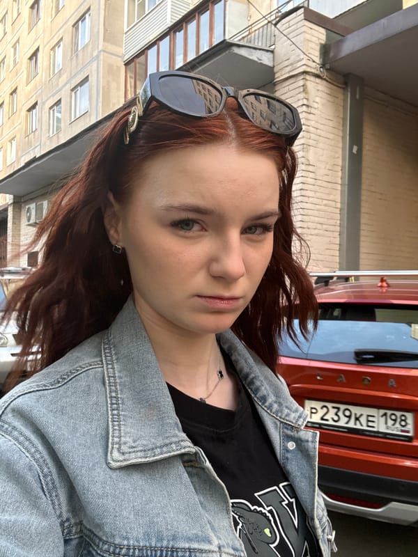 Woman poses for photos on Vsevolozhsk street