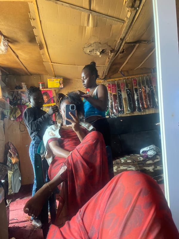 Hair salon session in Jos, caught in the mirror