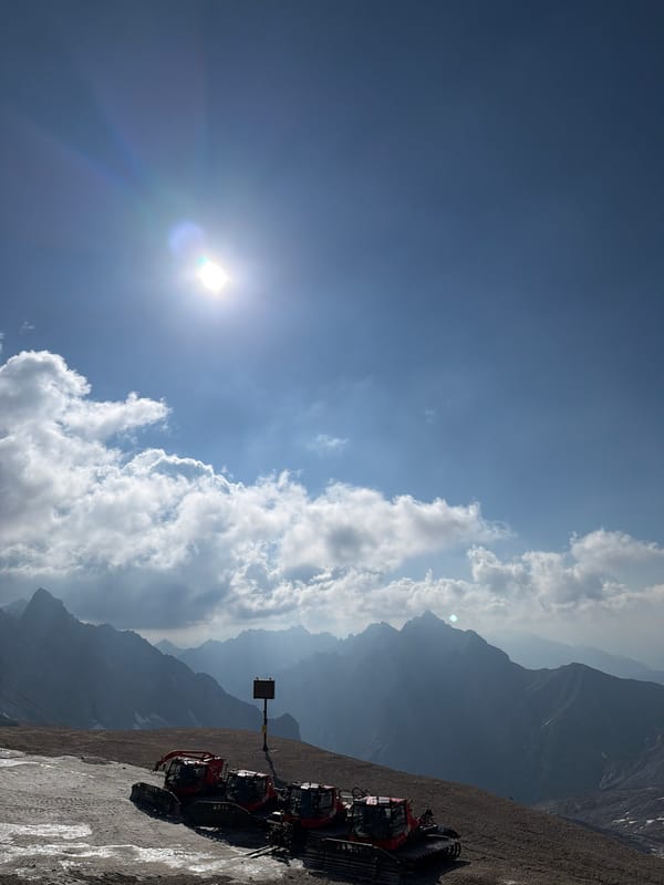 Morning at the Zugspitze: alpine views, snow groomers, and a Red Bull