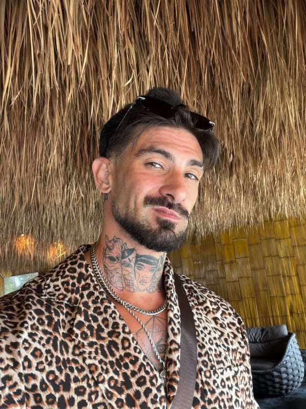 Tattooed man poses for photos in rural Thai village