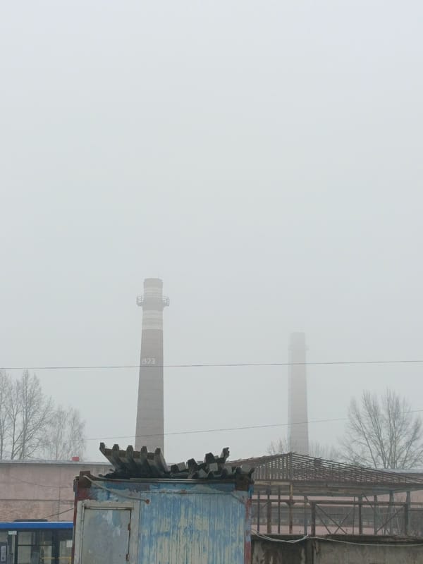 Foggy day documented in Noviy, Russia with industrial backdrop