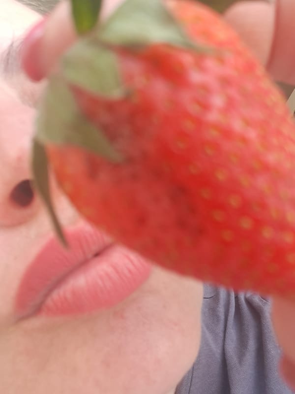 Woman poses with strawberries in Elektrostal, Russia