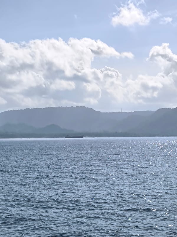 Boat passengers enjoy sunny morning journey off Indonesian coast