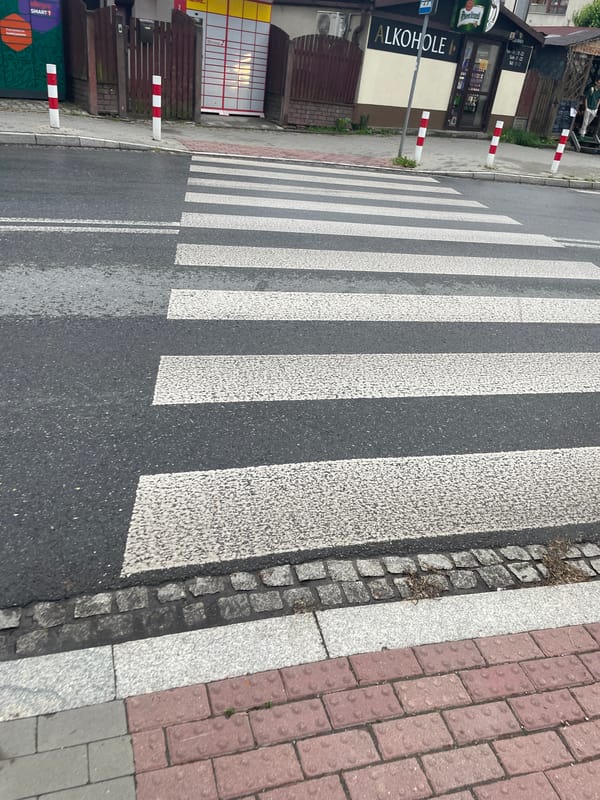 Overcast afternoon with wet streets documented across Kraków