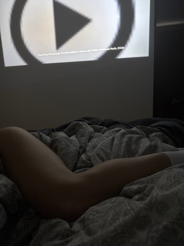 Person watches geometric video content in bed Monday evening